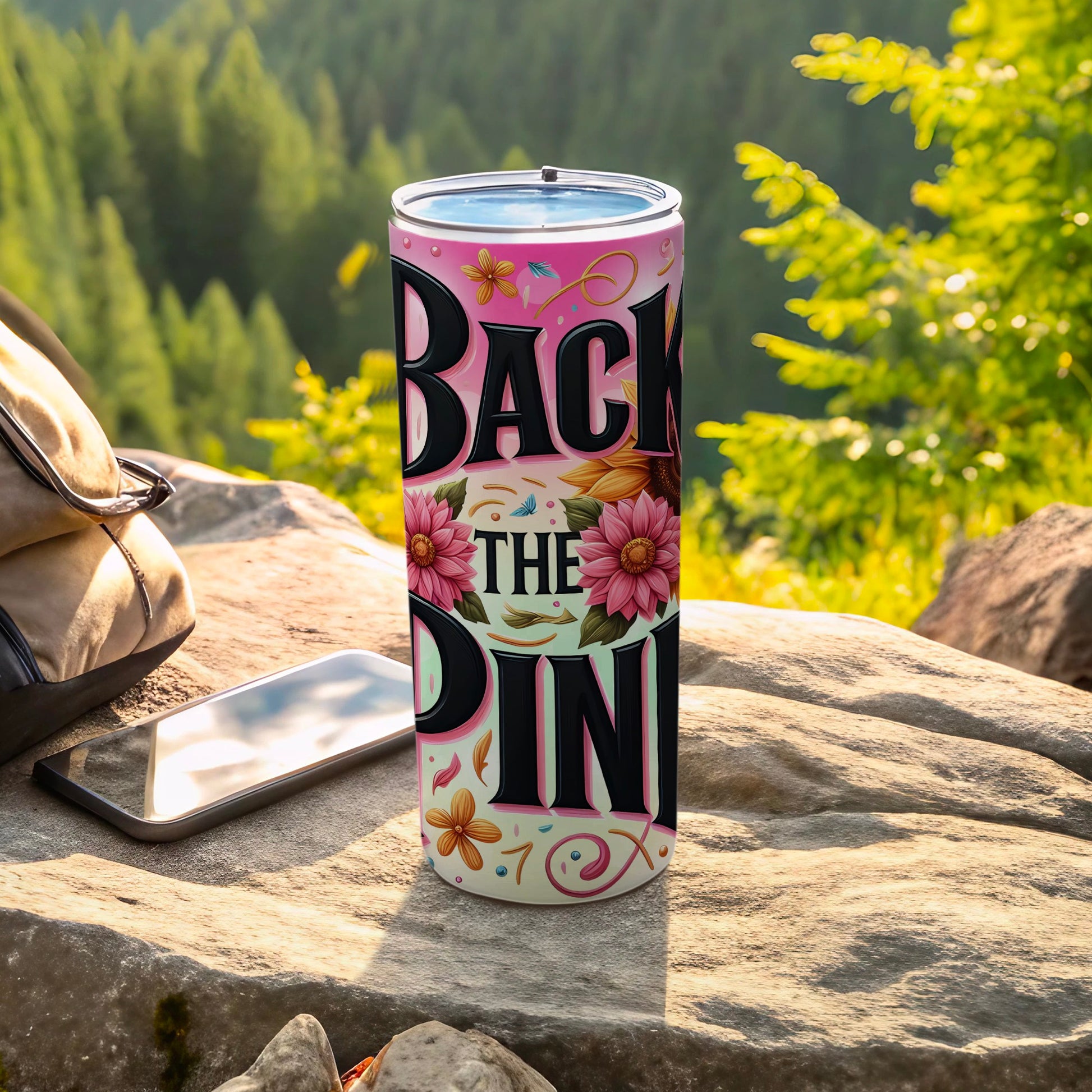 Pink tumbler with sunflowers and "Back the Pink" text on rock.