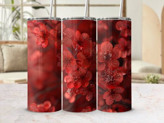 Red cherry blossoms on a white tumbler with a straw.