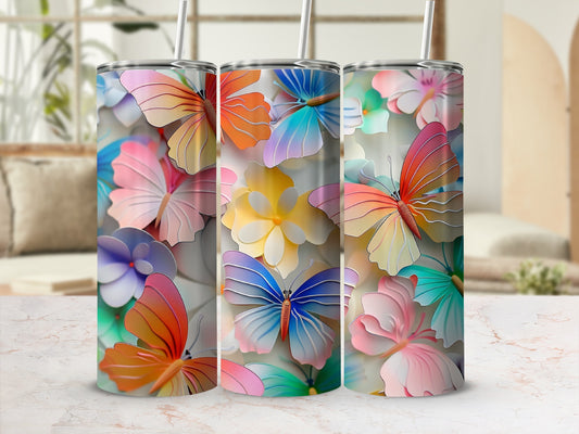 Three colorful tumblers with butterfly and floral designs.