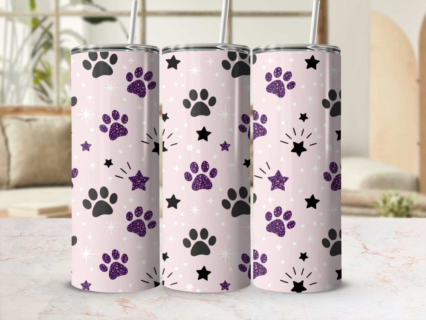 Pink tumbler with purple paw prints and black stars design.