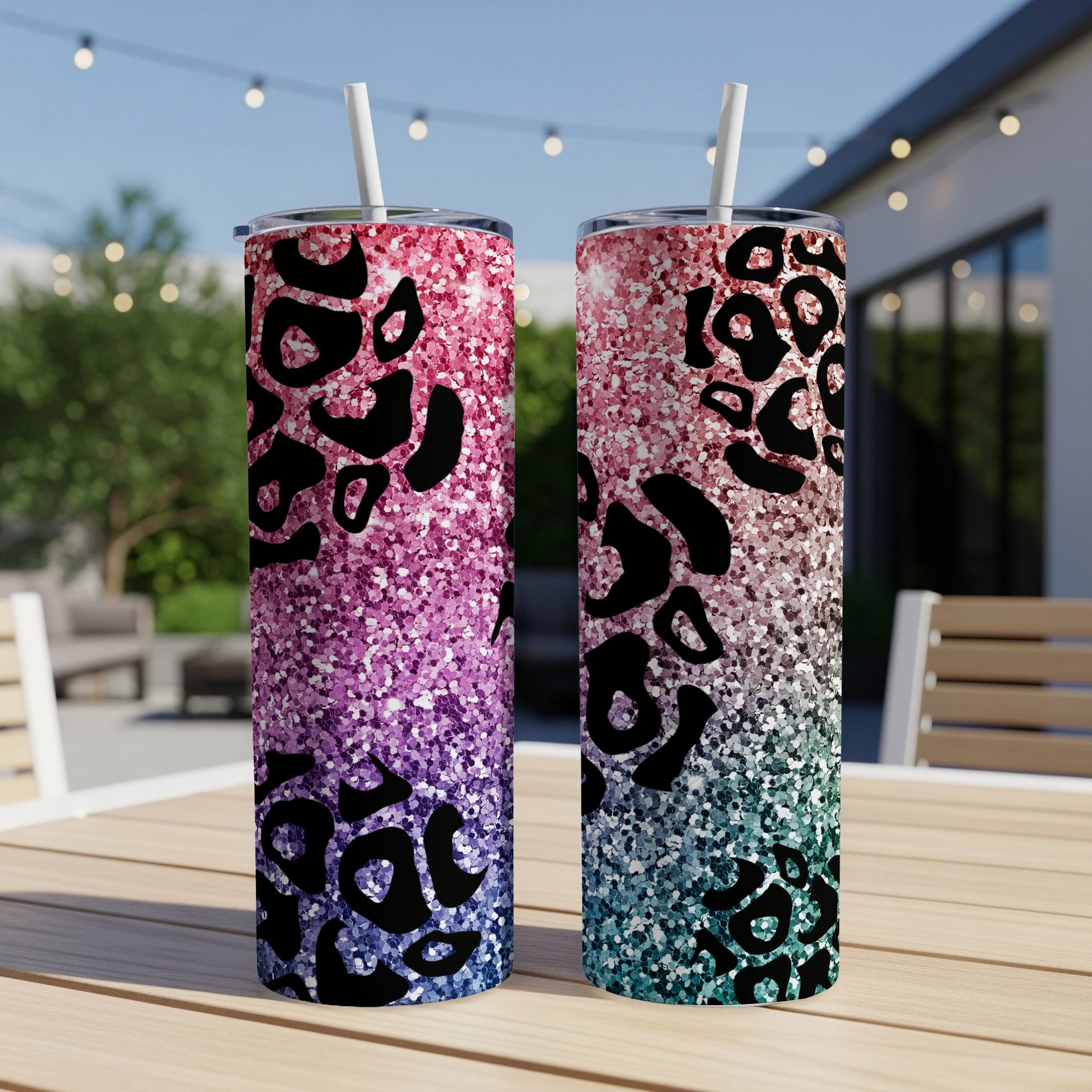 Two leopard print tumblers with glitter fade from pink to teal.
