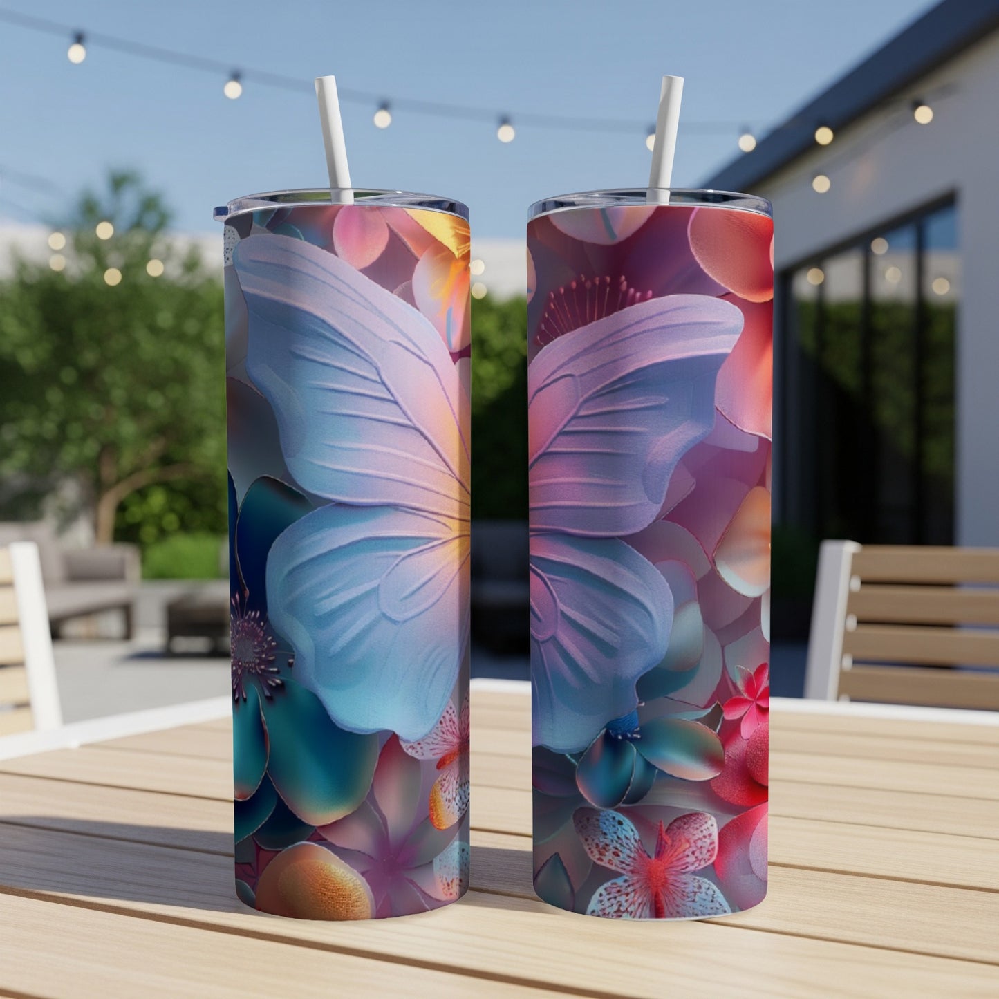 Two tall tumblers with butterfly and floral designs on a wooden table.