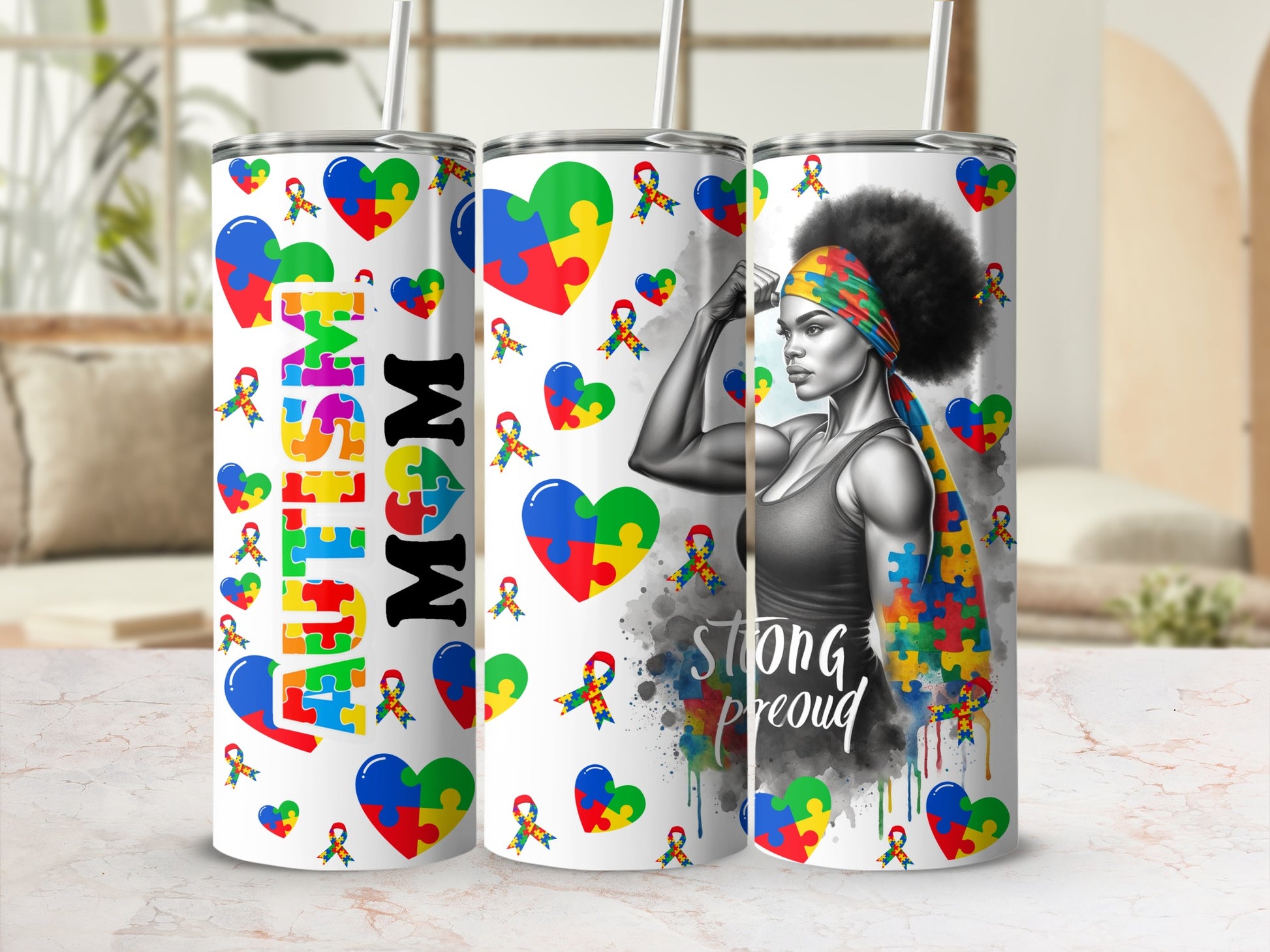Three tumblers featuring puzzle pieces, one with "MOM" and another with "STRONG PROUD".