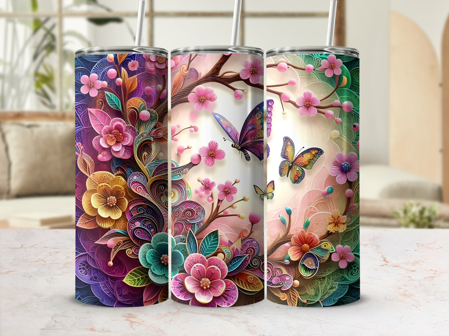 Three tall tumblers with vibrant floral and butterfly designs.