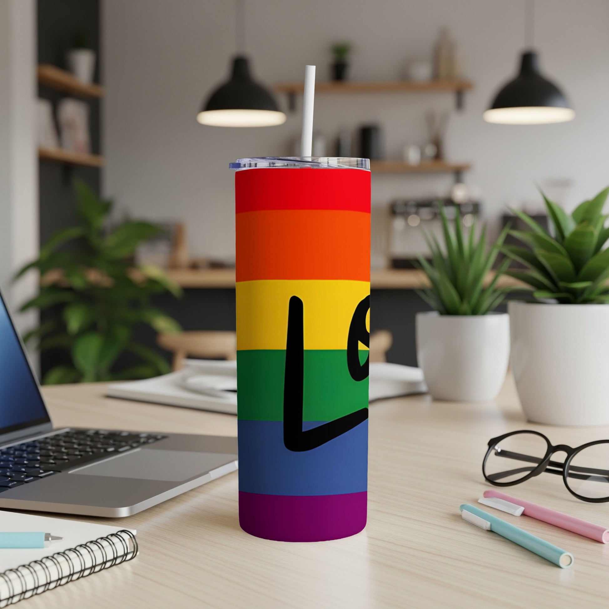 Rainbow tumbler with "Love" in black text.