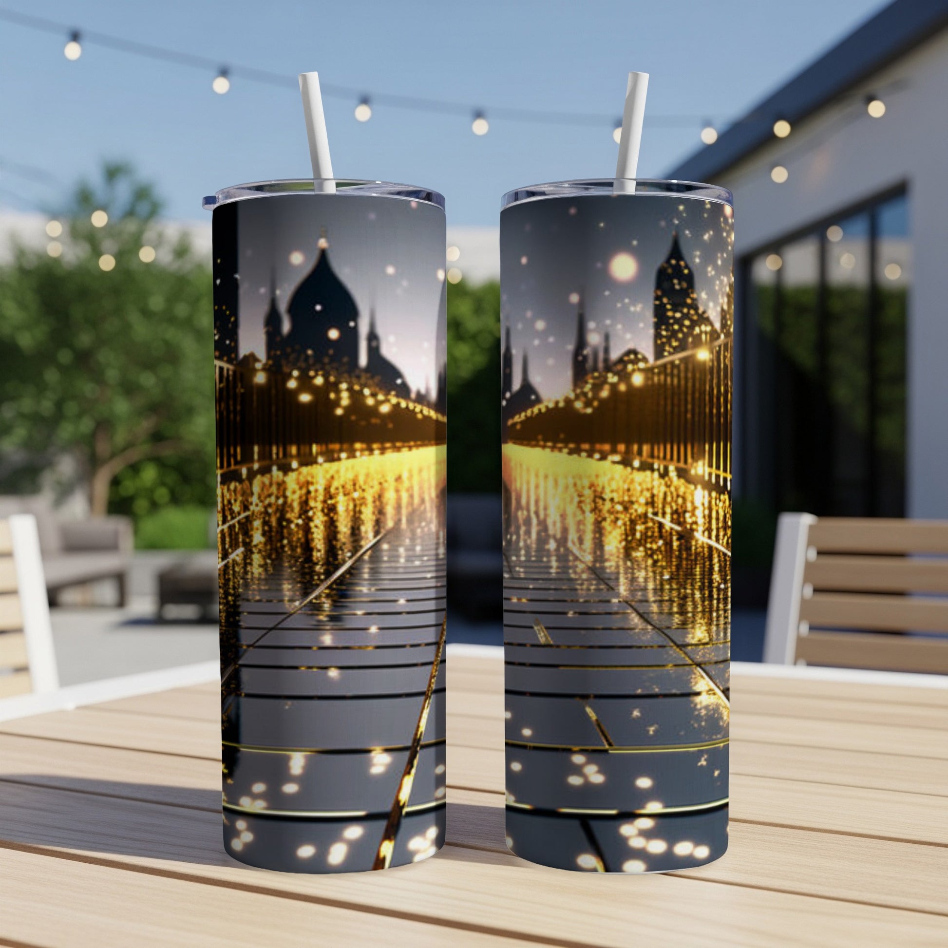 Two tumblers with a city skyline and sparkling lights reflection on a table.