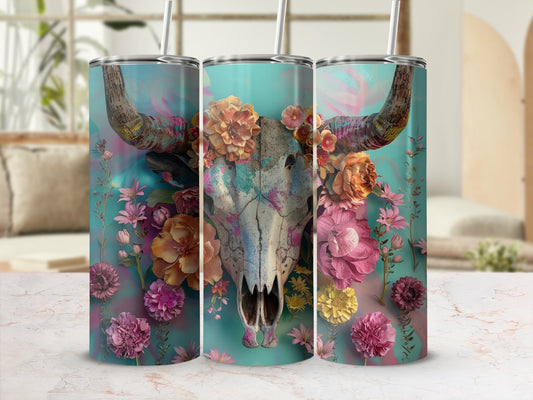 Bull skull with colorful floral arrangement on a teal background tumbler.