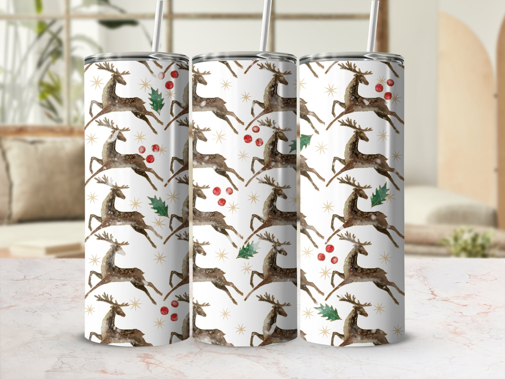 Three tumblers with a white background and falling reindeer and holly pattern.