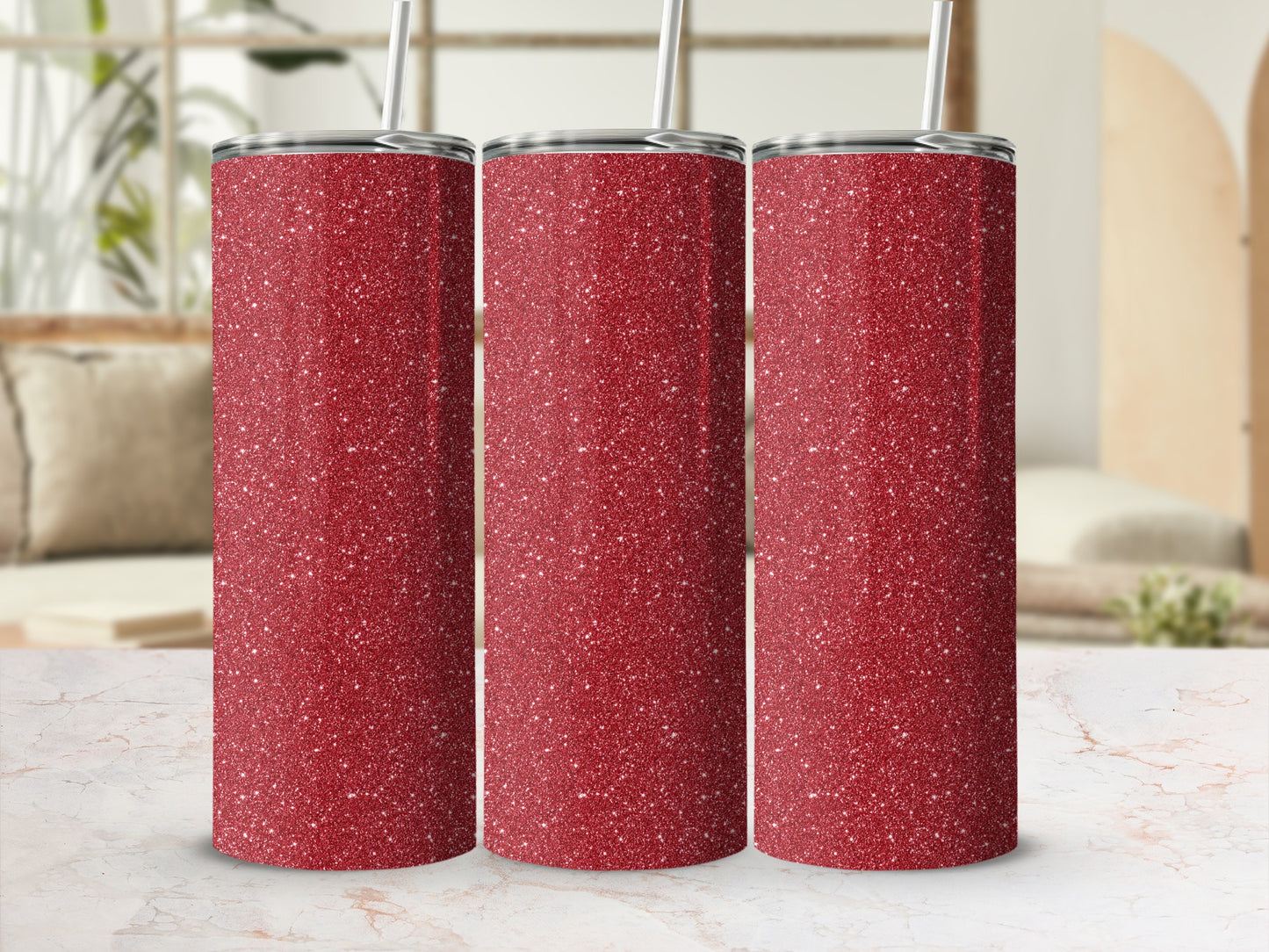 Three tall red glitter tumblers with straws on a marble surface.