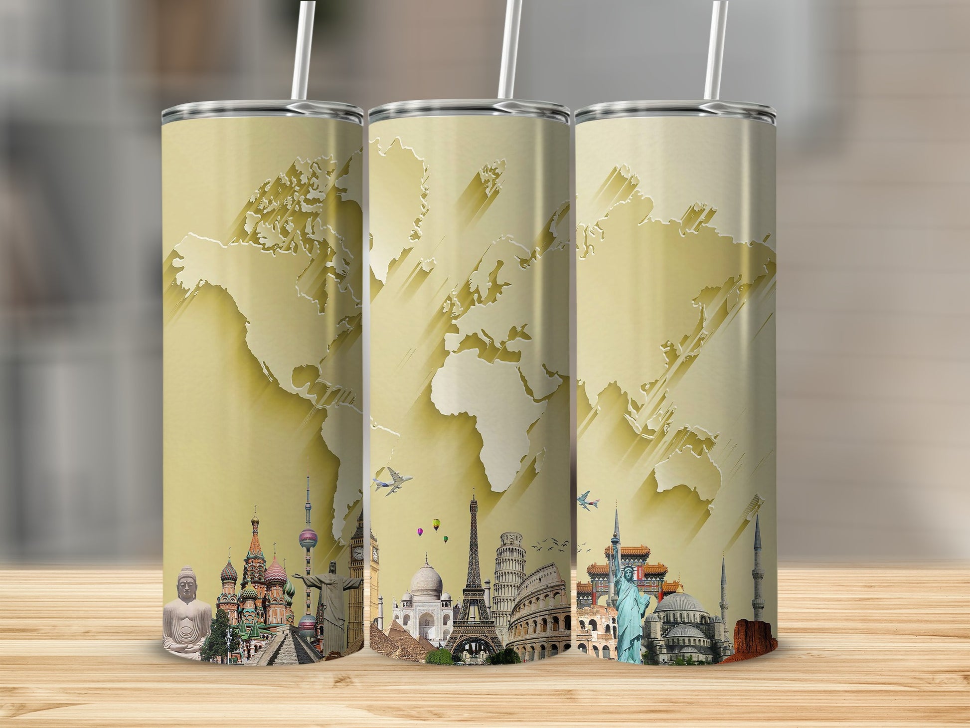 Three tumblers featuring a gold world map and iconic landmarks collage design.