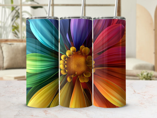 Three tumblers with colorful flower petal designs and straws.