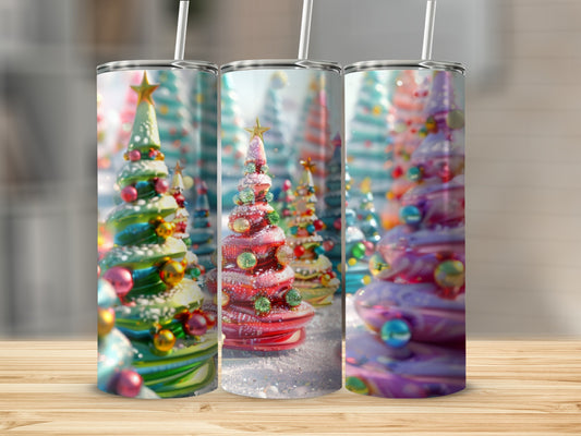Three festive, glittery Christmas trees with colorful ornaments on a wooden surface.