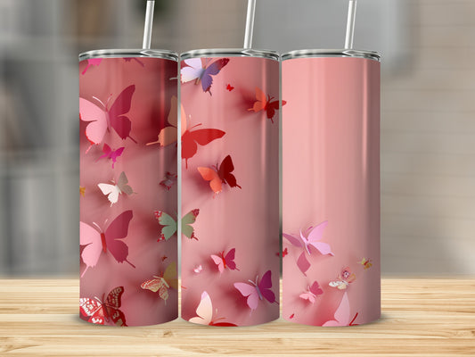 Three pink tumblers with butterfly designs and straws.