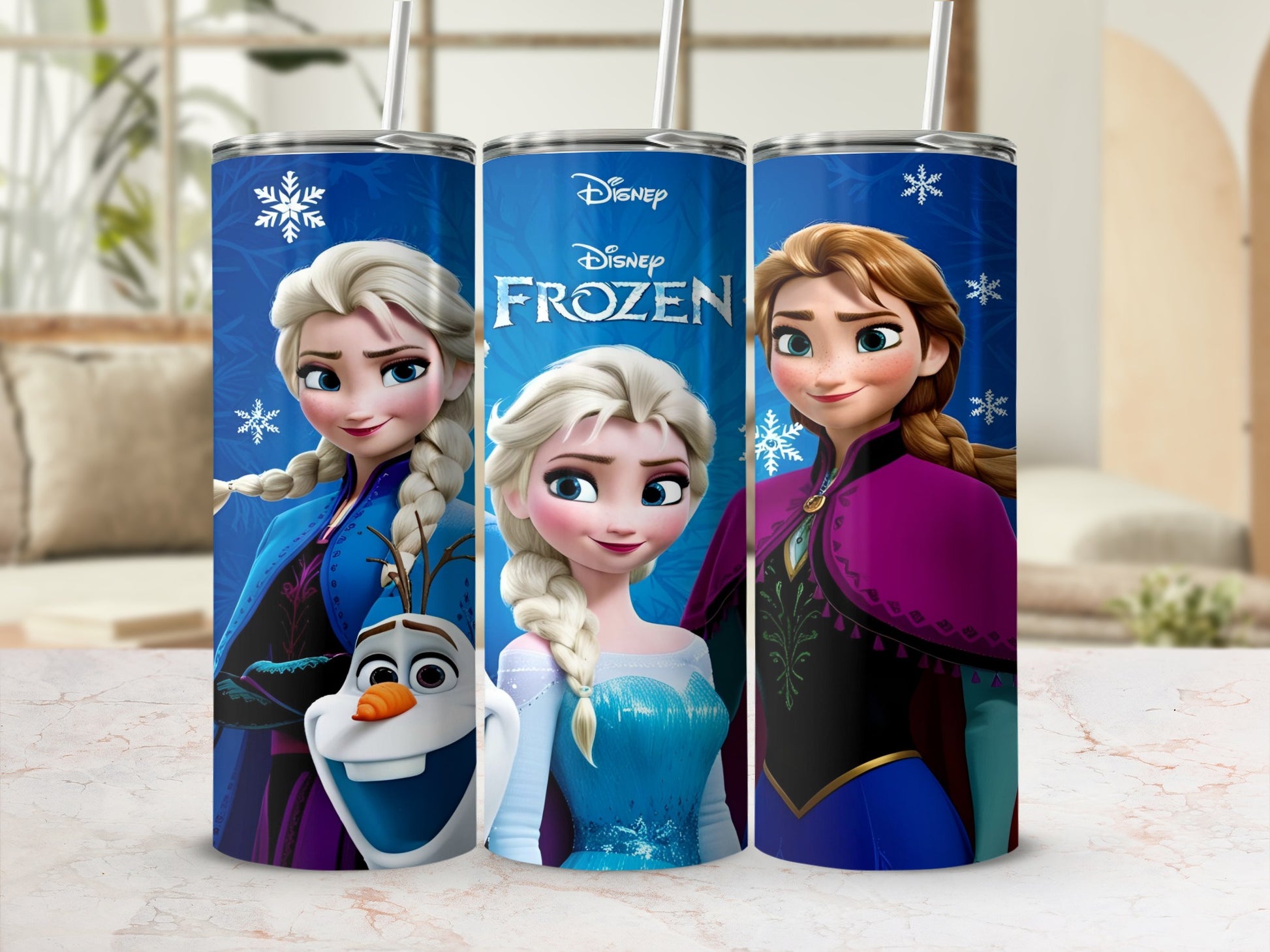 Three Disney Frozen tumblers with Elsa and Olaf on a blue background.
