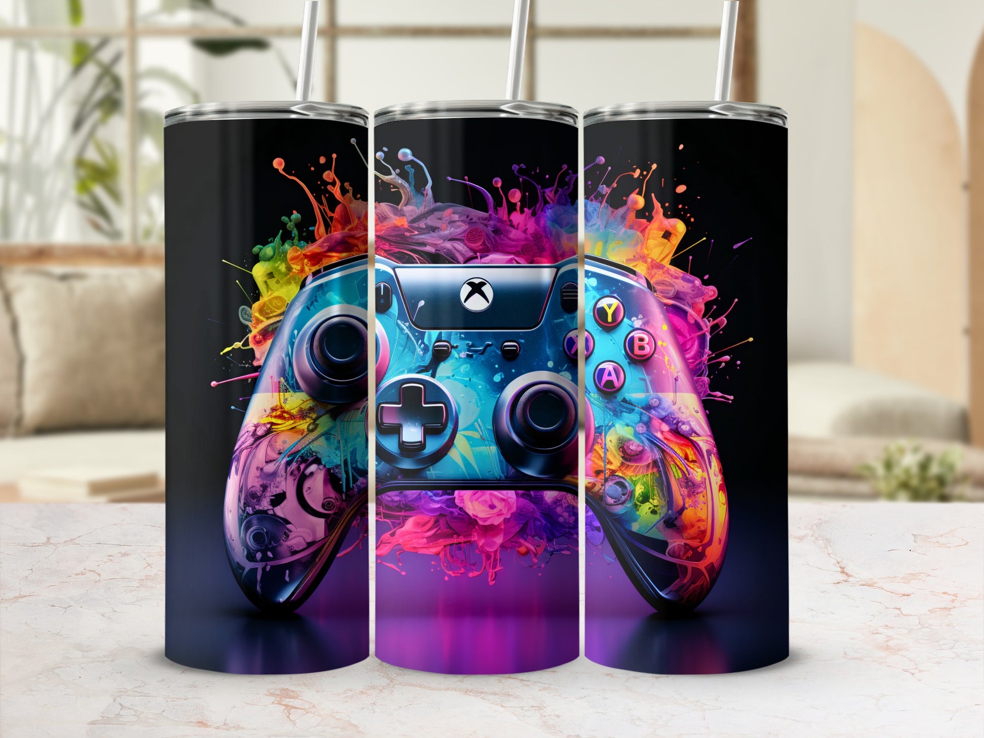 Video game controller with vibrant paint splash design, on a marble surface.