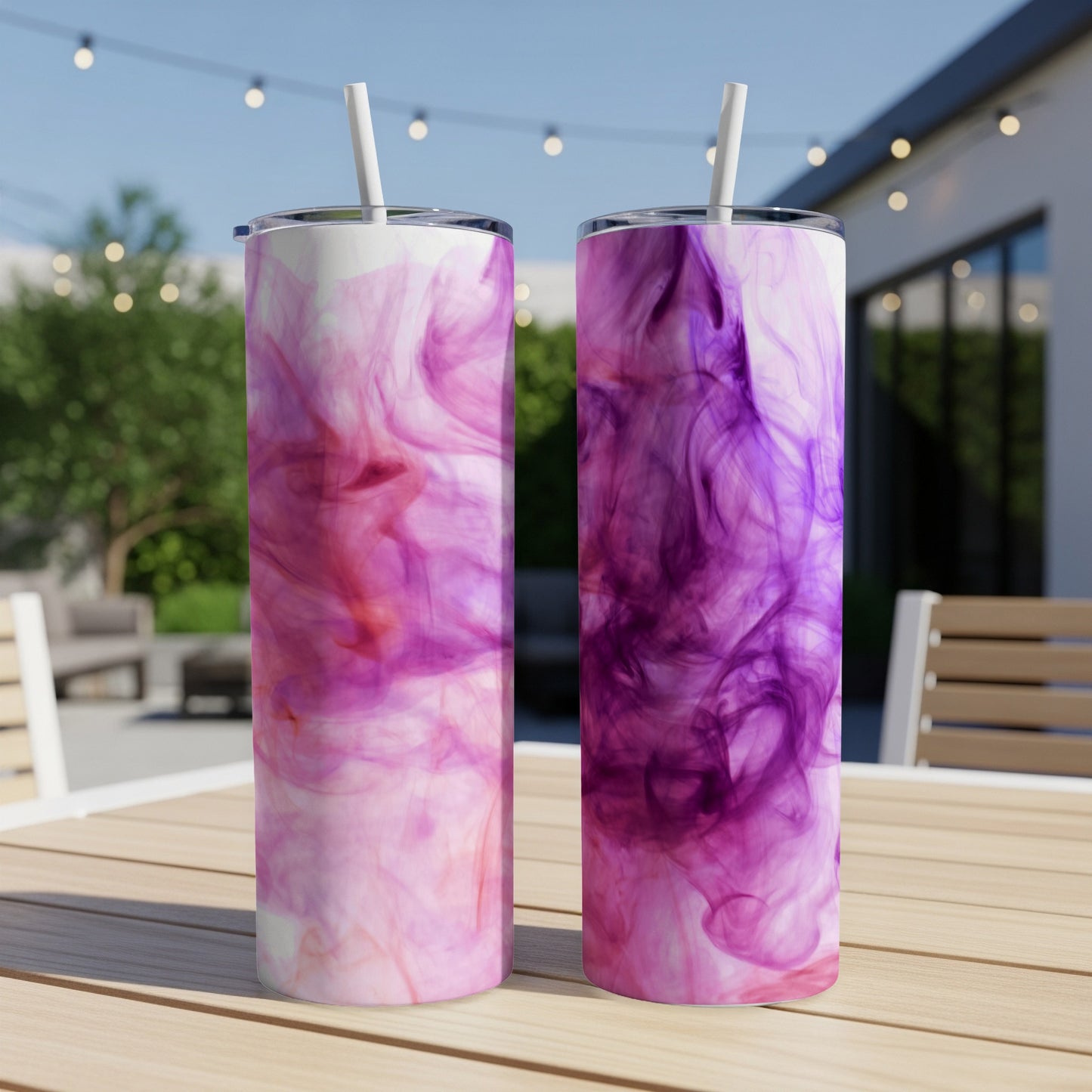 Two tumblers with pink and purple smoke-like patterns sit on a wooden table.