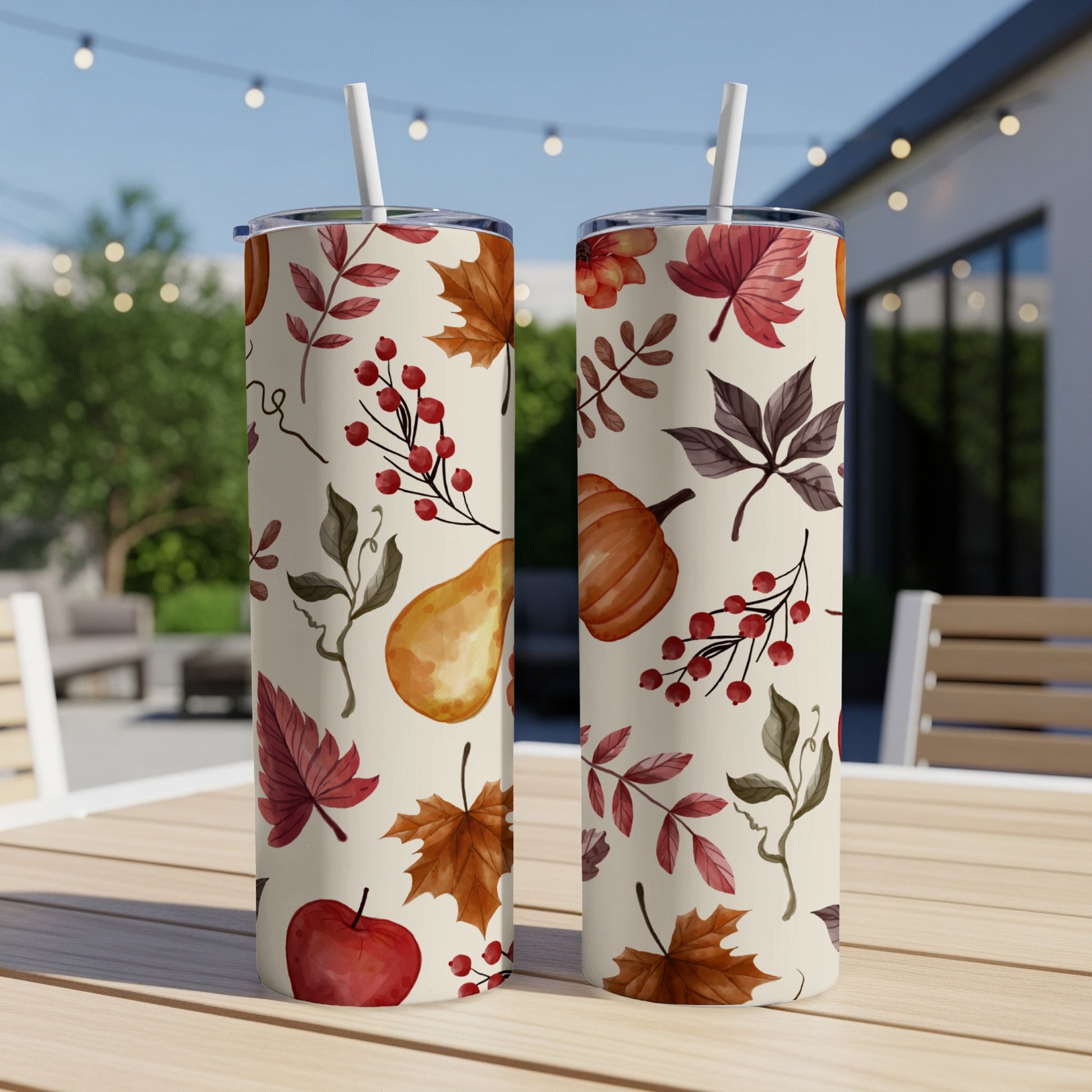 Two tall, insulated tumblers with fall leaf, berry, pumpkin, and apple pattern.