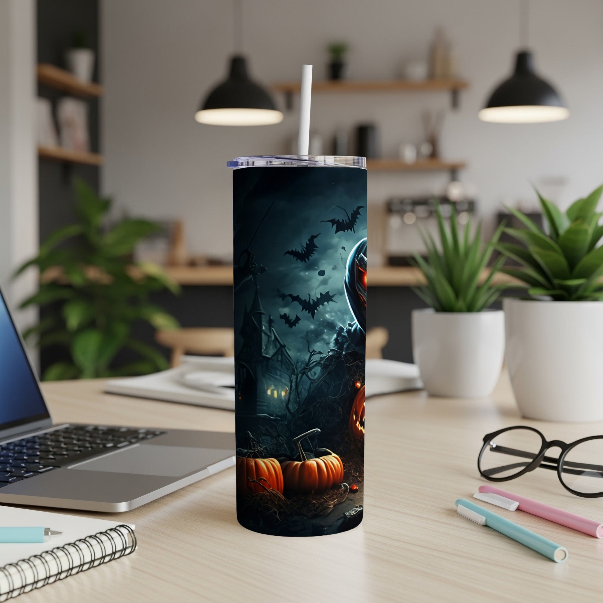 Halloween tumbler with pumpkins, bats, haunted house, and a grim reaper.