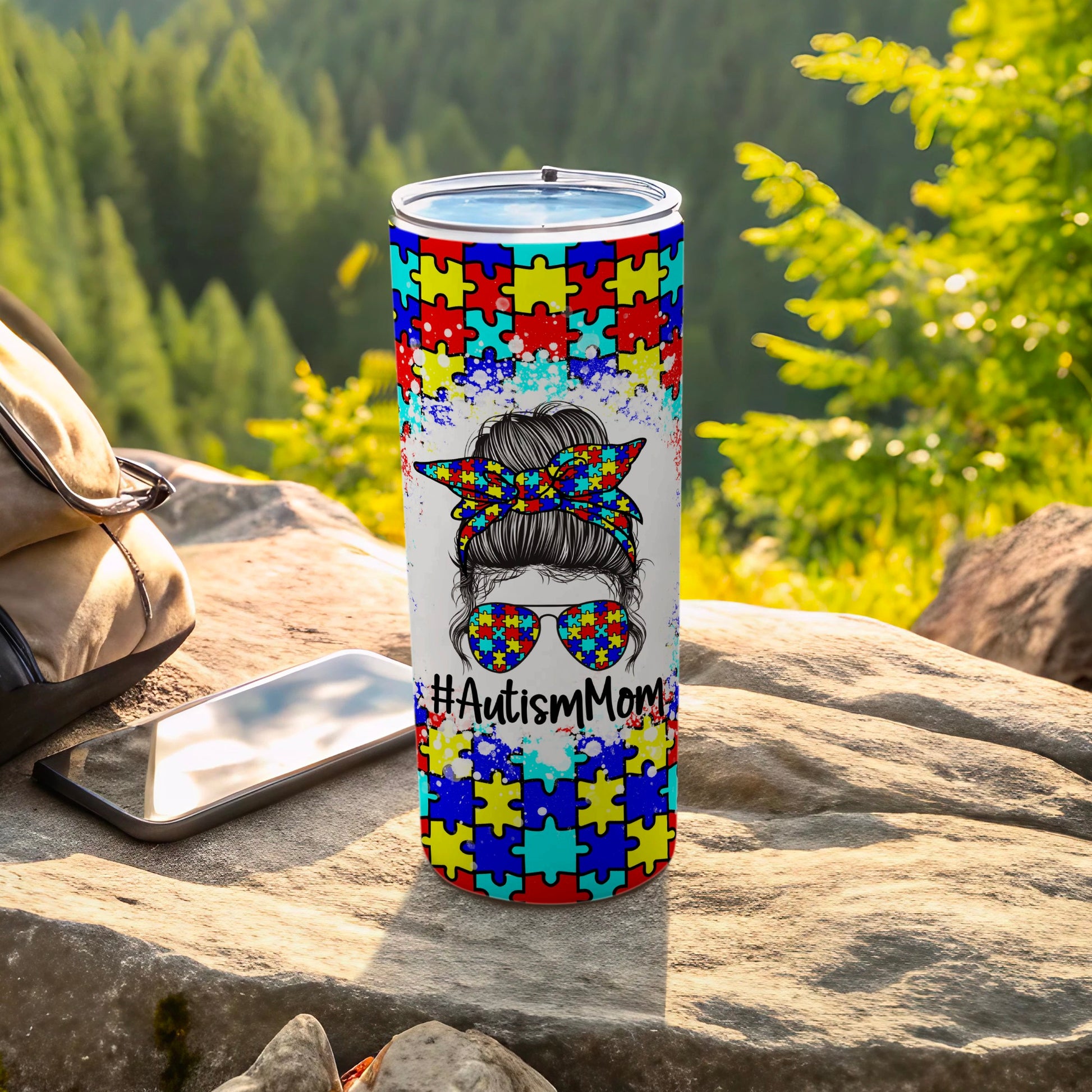 Autism Mom tumbler with puzzle piece pattern and sunglasses.
