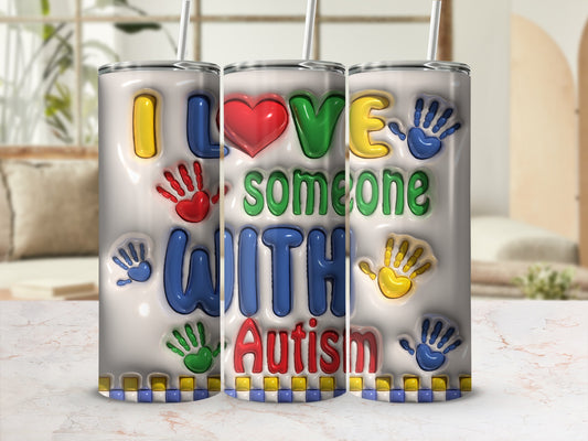 Tumbler with "I Love Someone With Autism" and colorful handprints.
