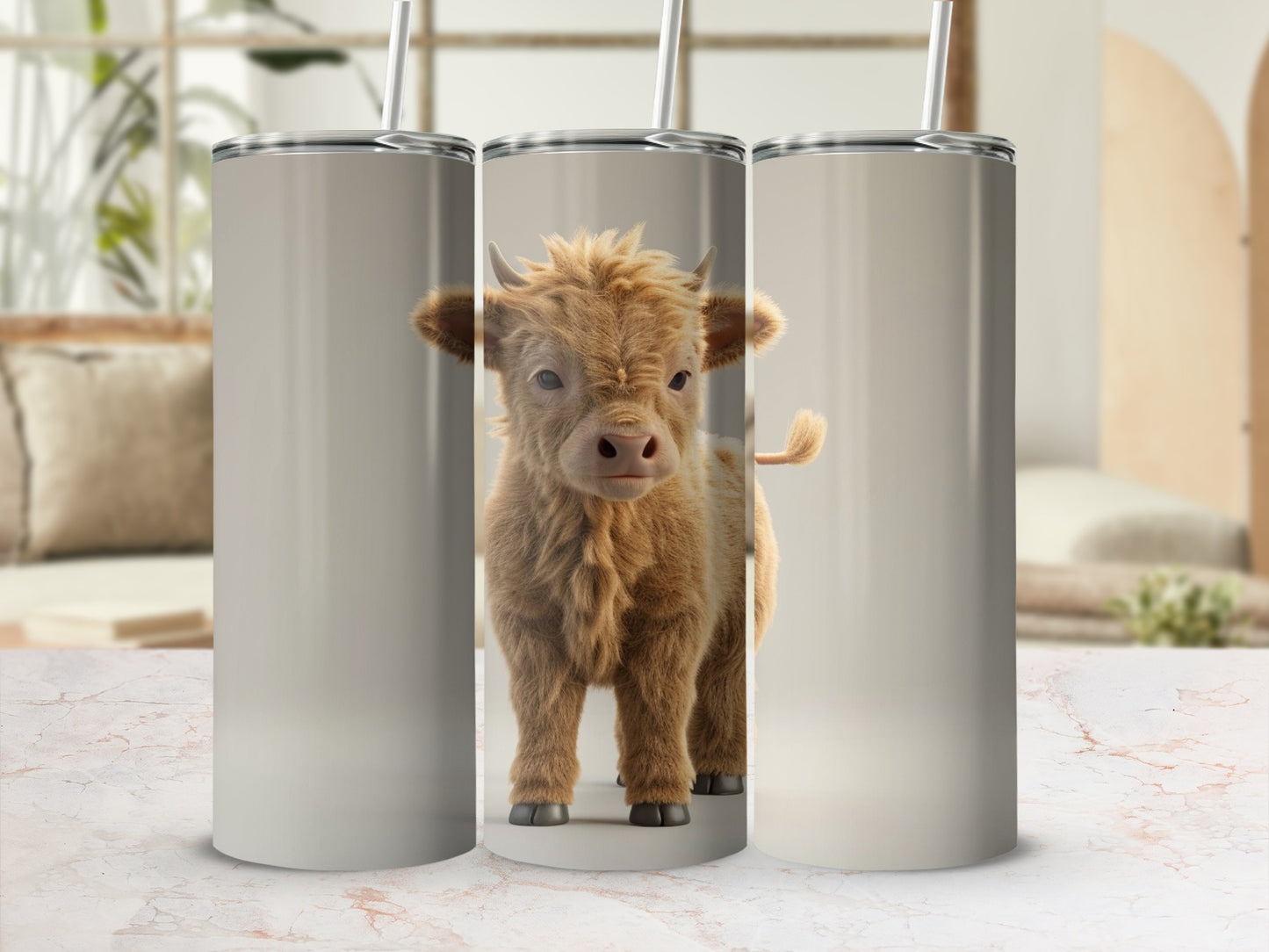 Fluffy brown baby Highland cow with horns on a tan tumbler.