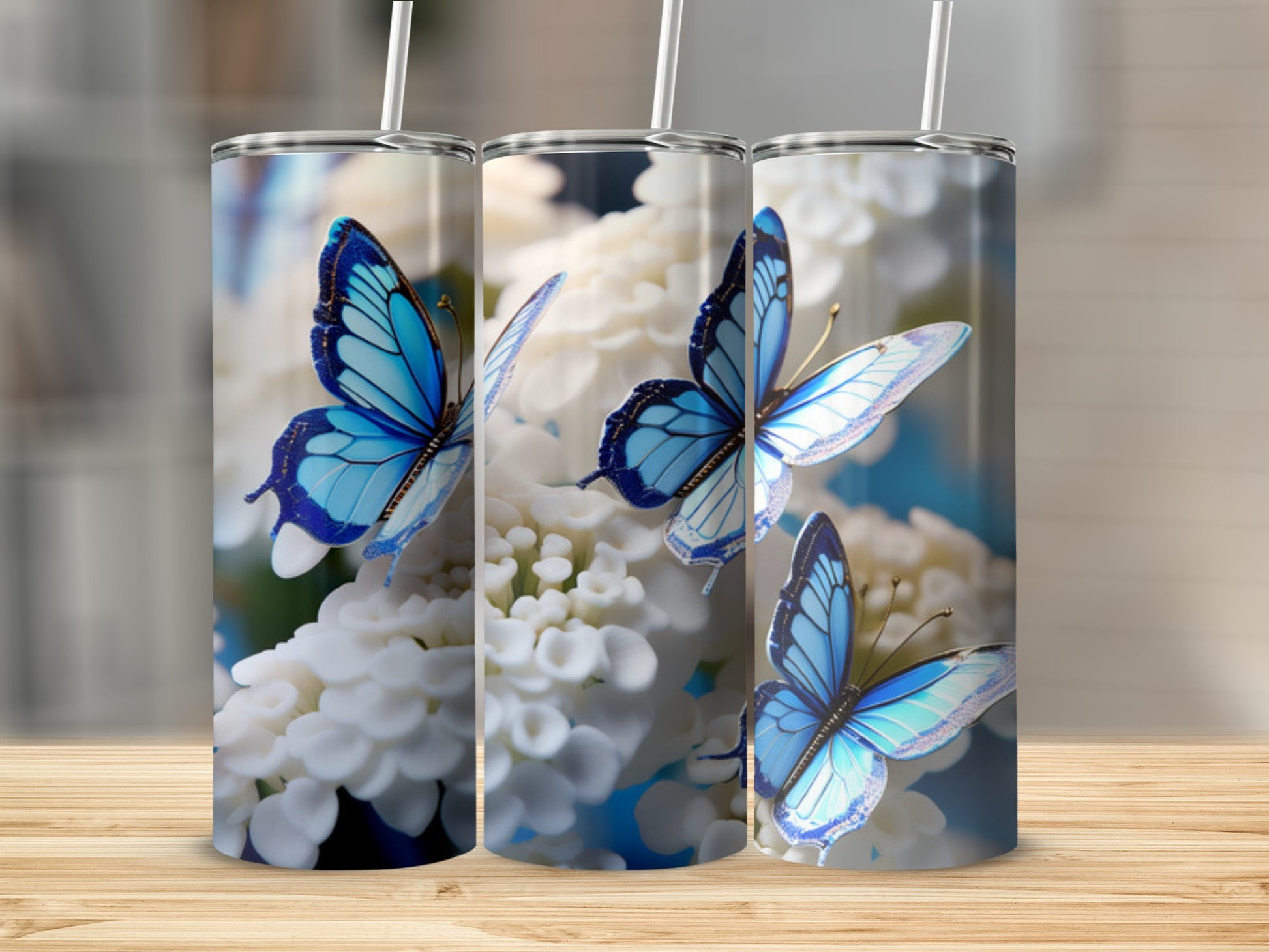 Three tumblers with blue butterflies and white flowers design.