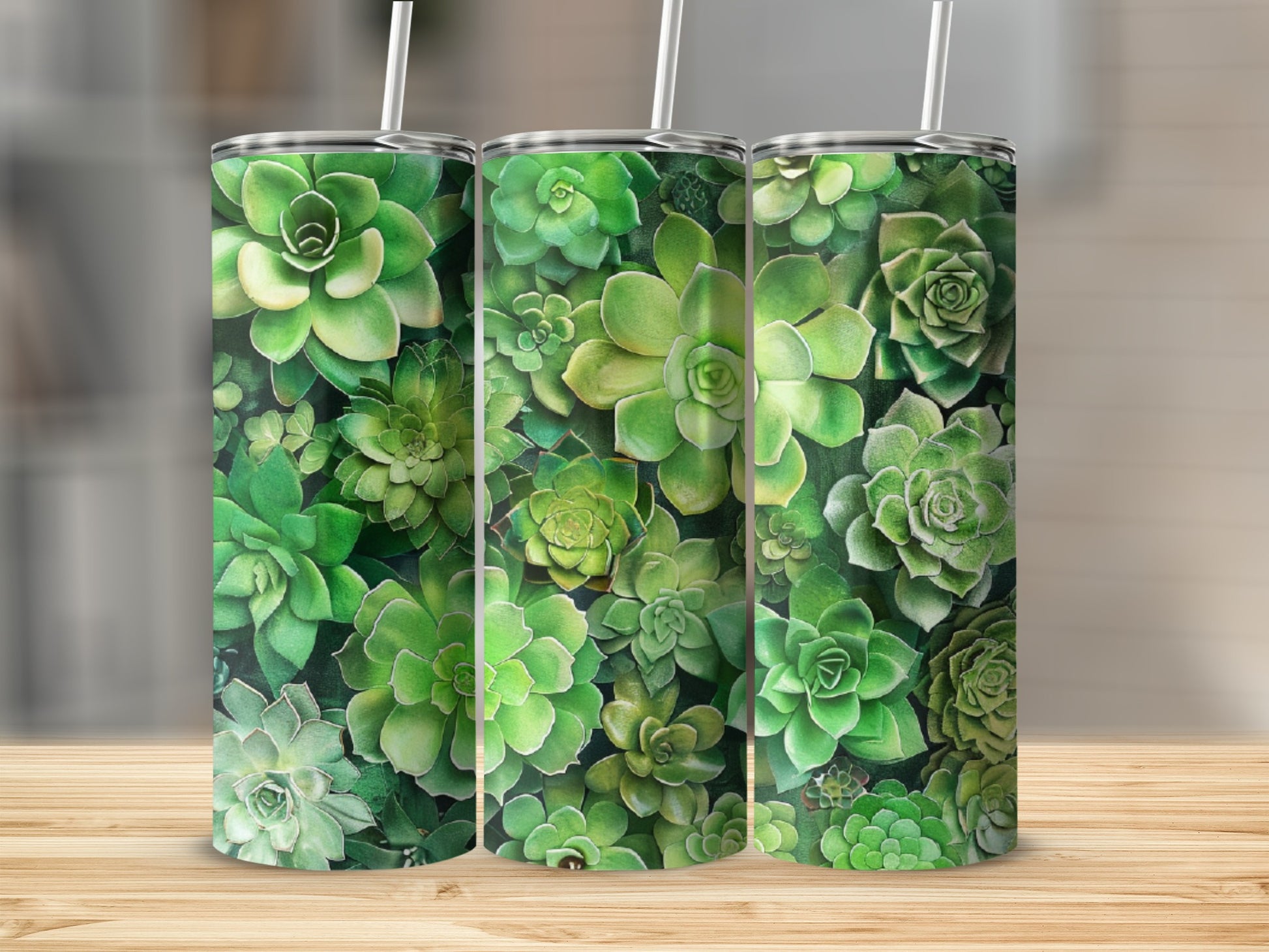 Green succulents arranged in a repeating pattern on three tall tumblers.