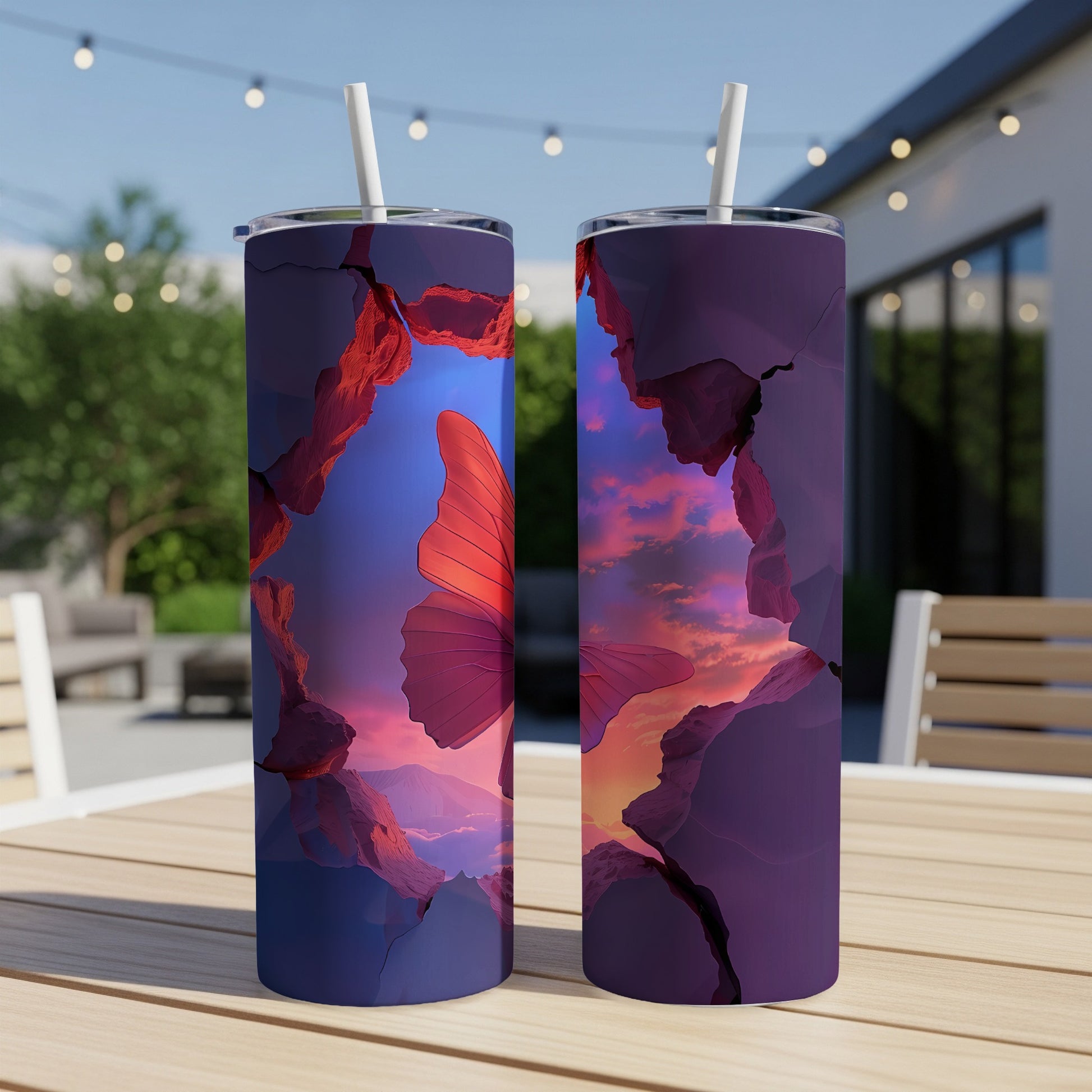 Cracked purple frame reveals butterfly and sunset sky on two tumblers.