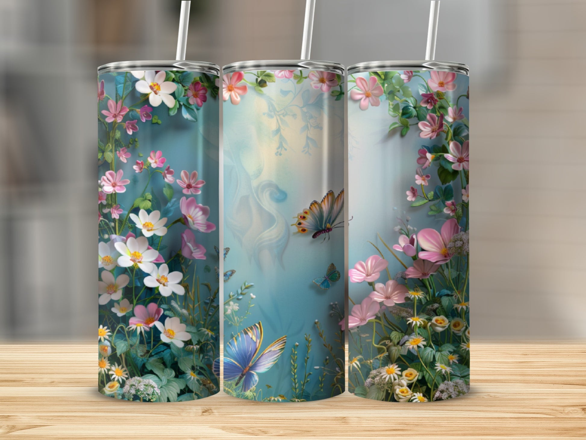 Three tumblers with a watercolor floral and butterfly design.