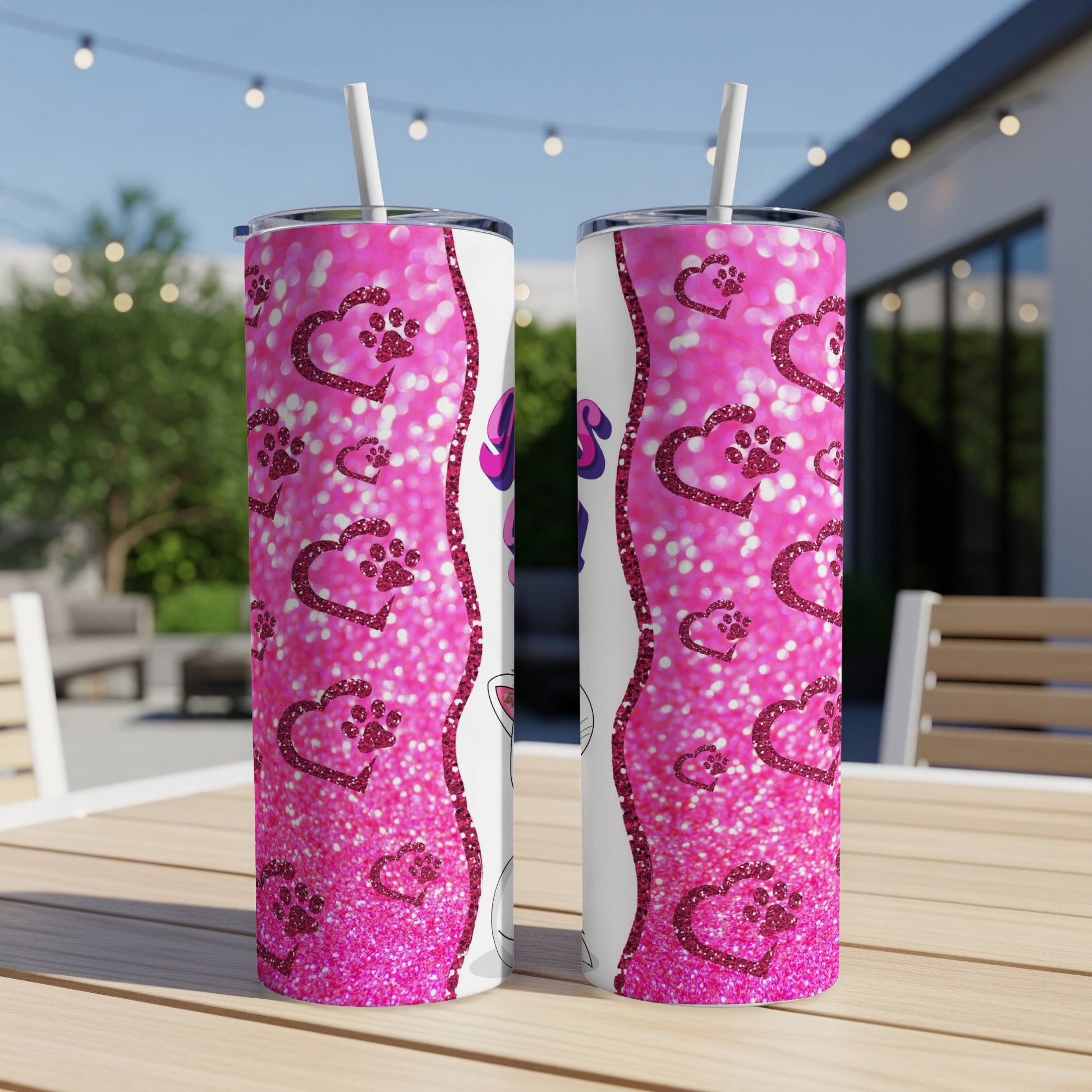 Two glittery pink tumblers with paw prints and sparkles.