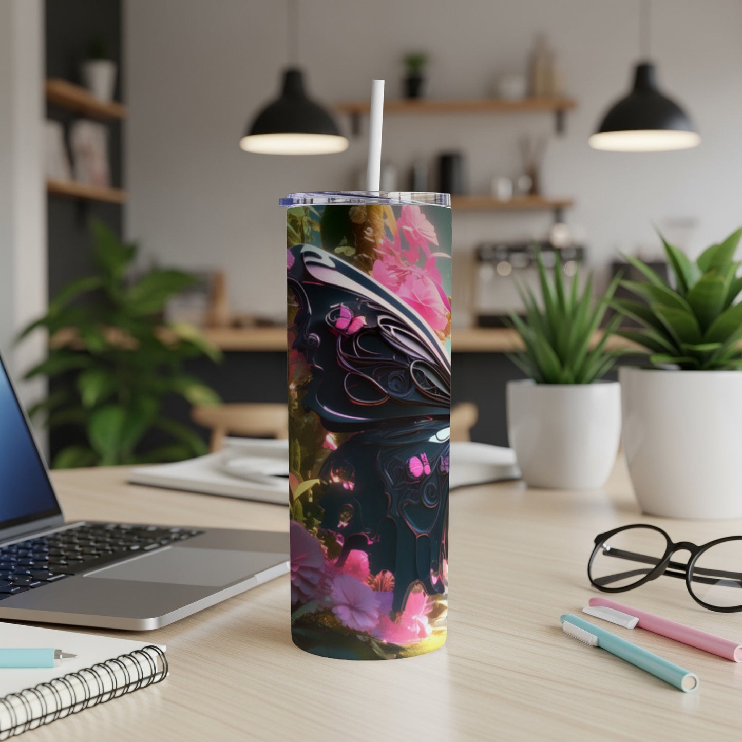 Tumbler with colorful butterfly and floral design, on a desk.