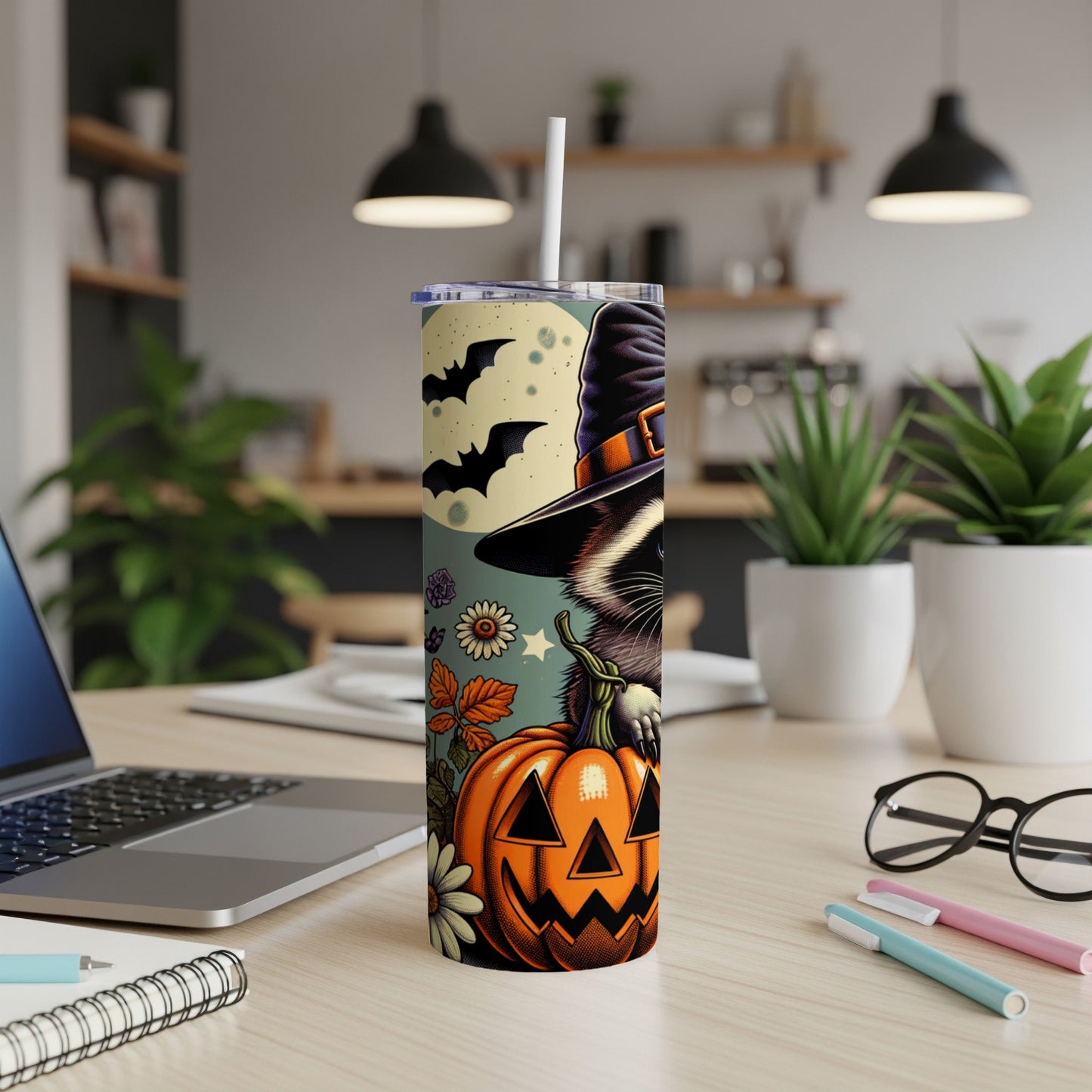 Halloween tumbler with raccoon in witch hat and jack-o'-lantern.