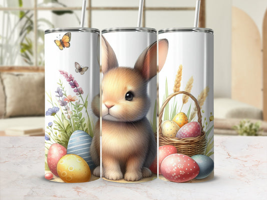 Easter bunny with painted eggs and wildflowers on a tumbler.