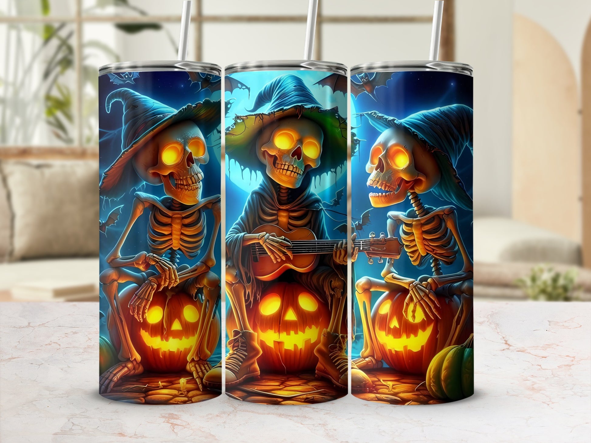 Three tumblers with Halloween skeletons playing guitars and sitting on pumpkins.