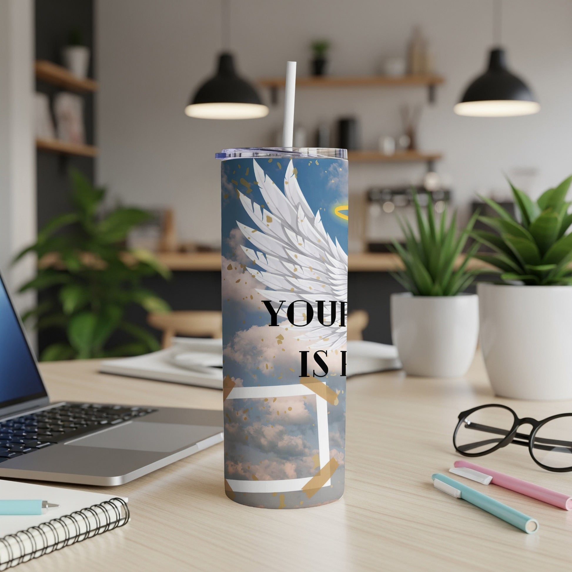 Tumbler with white angel wings, halo, and "YOUR IS I" text on a sky background.