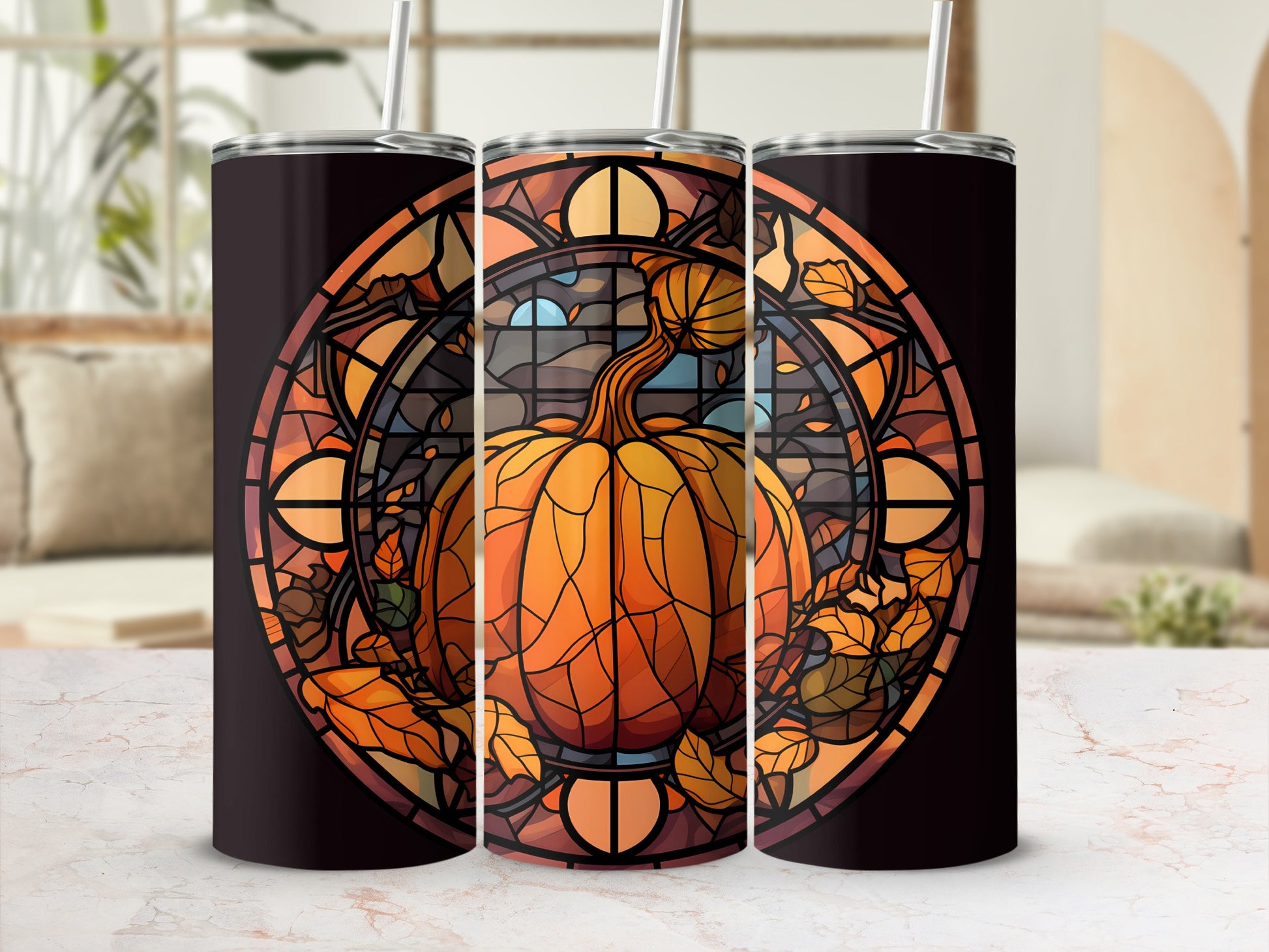 Pumpkin stained glass art on three tumblers with straws.
