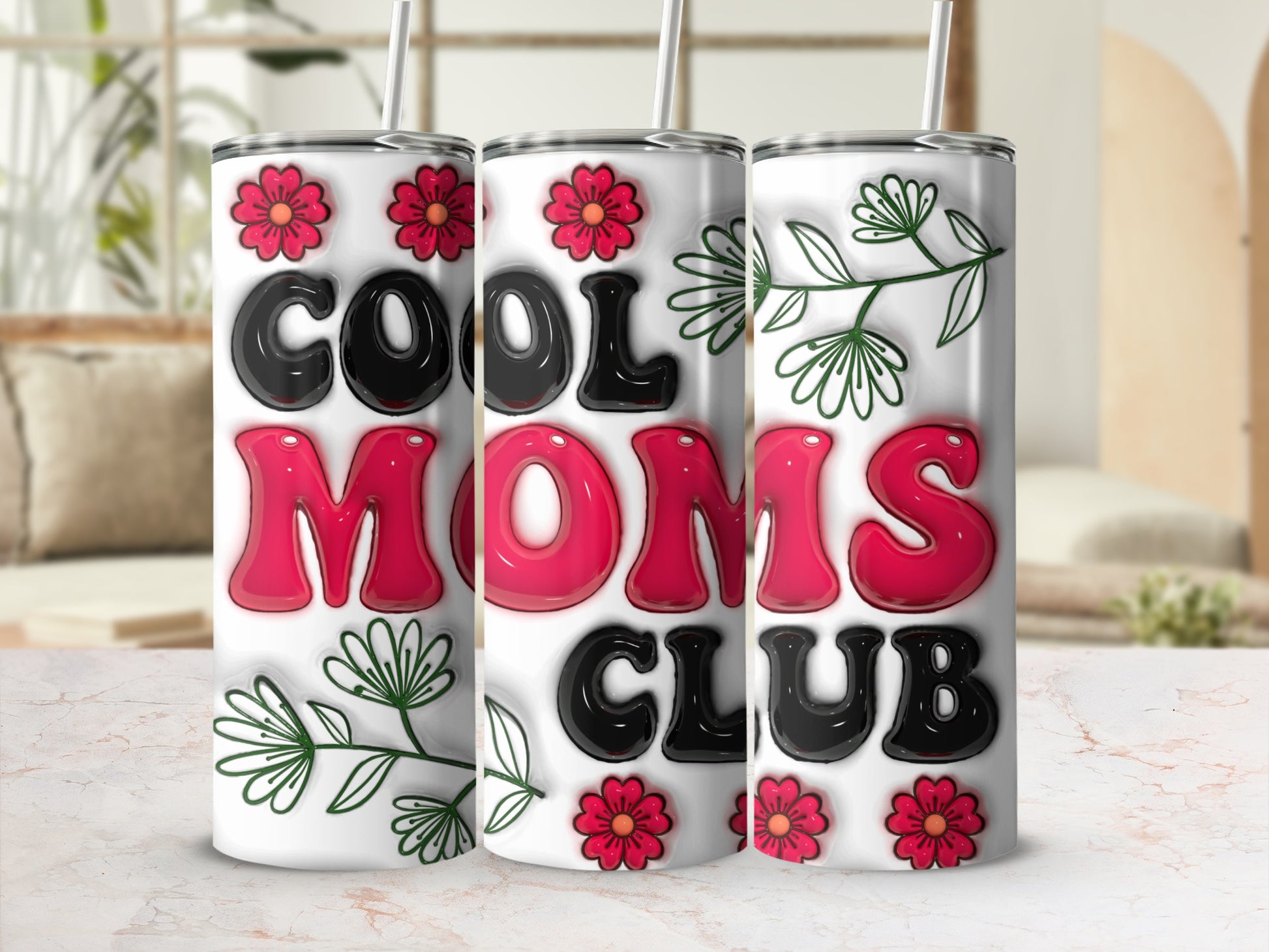 "Cool Moms Club" tumbler with floral accents and a straw.