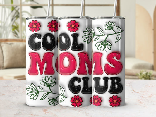 "Cool Moms Club" tumbler with floral accents and a straw.