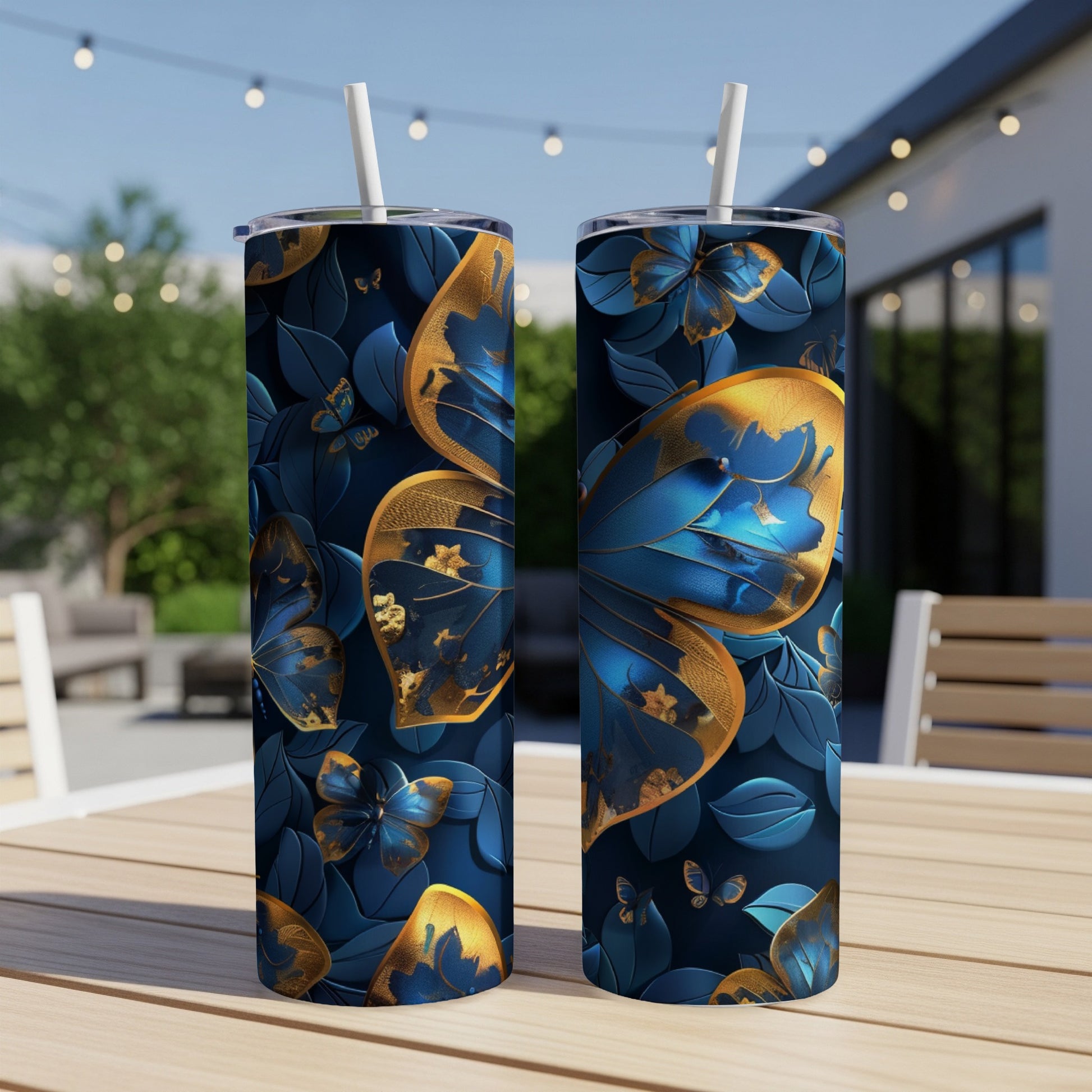 Two tumblers with blue and gold butterfly and floral pattern.