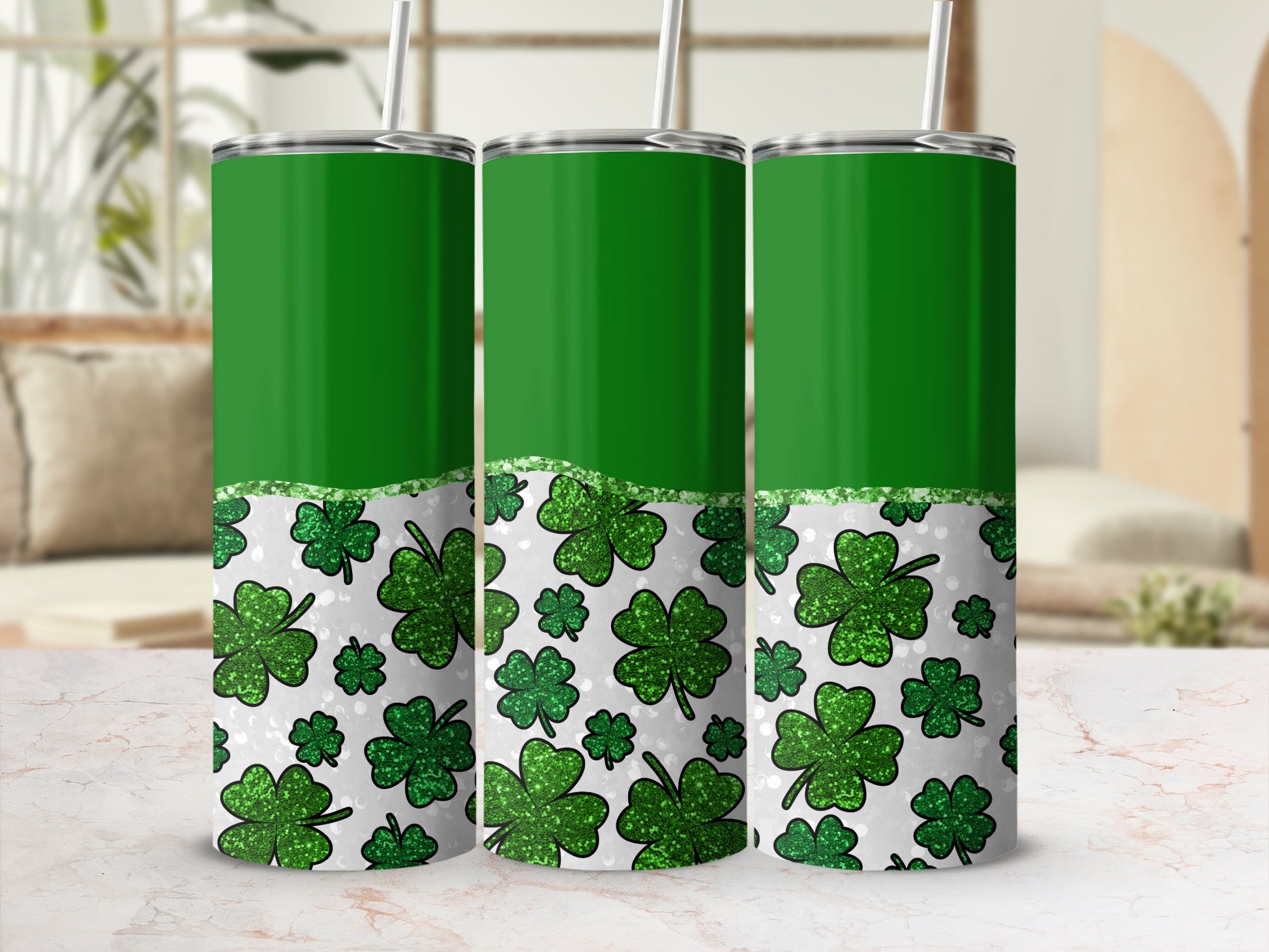 Three green tumblers with shamrocks and glitter.