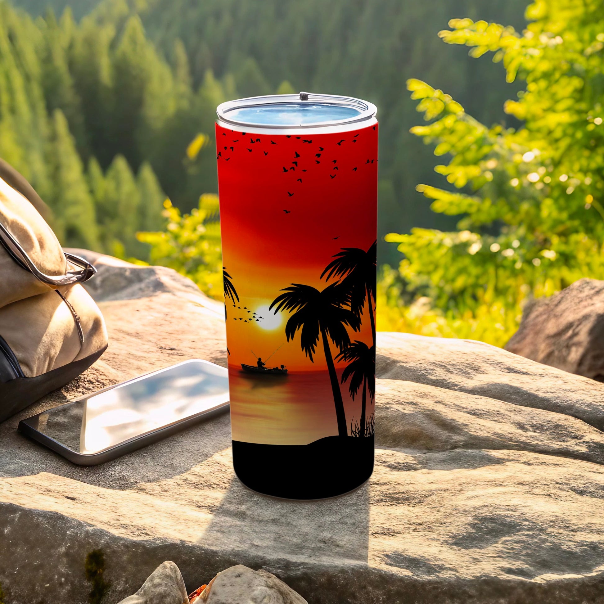 Tumbler with sunset, palm trees, and fishing scene design.