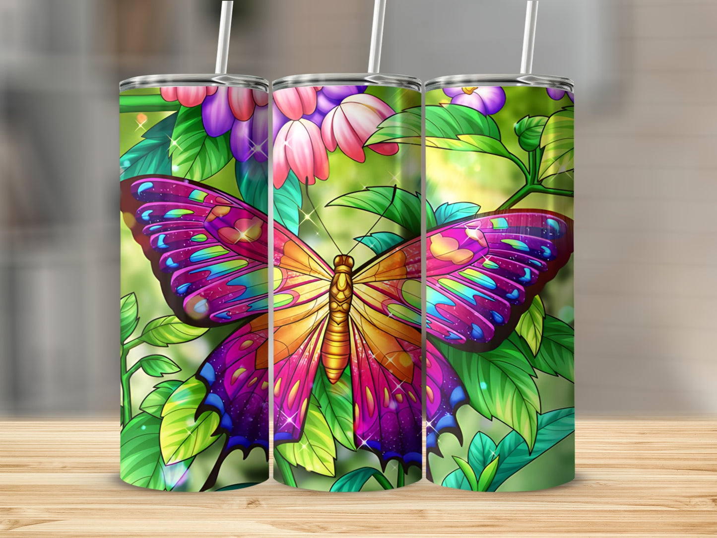 Three tumblers featuring a vibrant, colorful butterfly and floral design.