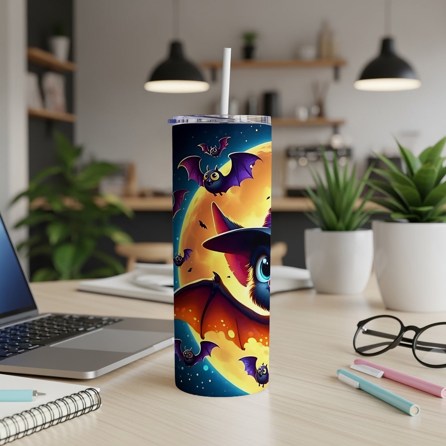 Tumbler with cartoon bats flying against a large full moon and starry night sky.