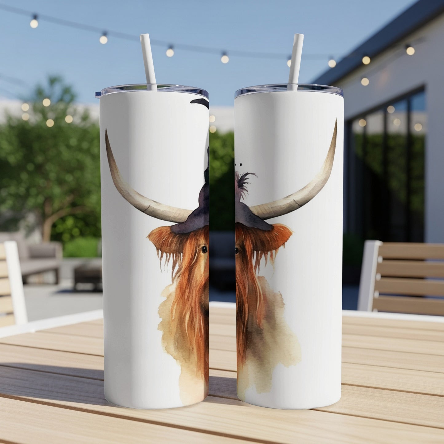 Two tumblers featuring a watercolor Highland cow with a witch hat.