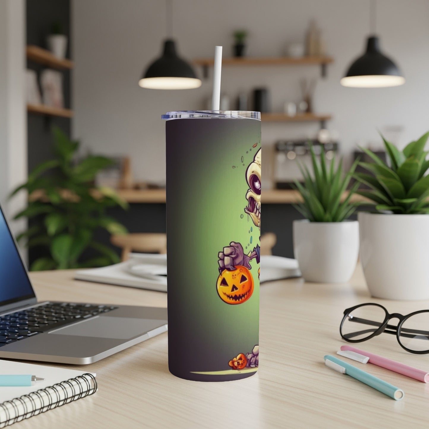 Tall tumbler with cartoon zombie holding a Halloween pumpkin.