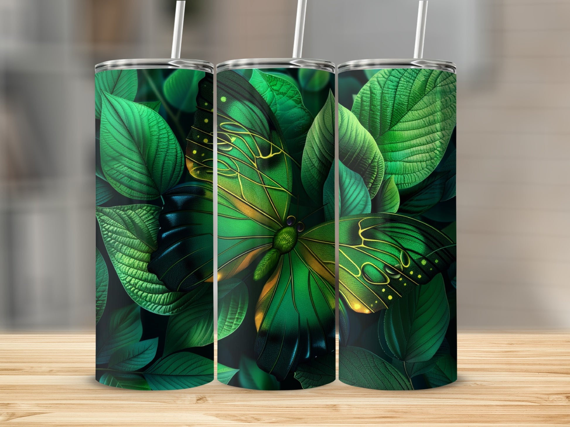 Green butterfly with leafy background on three tumblers.