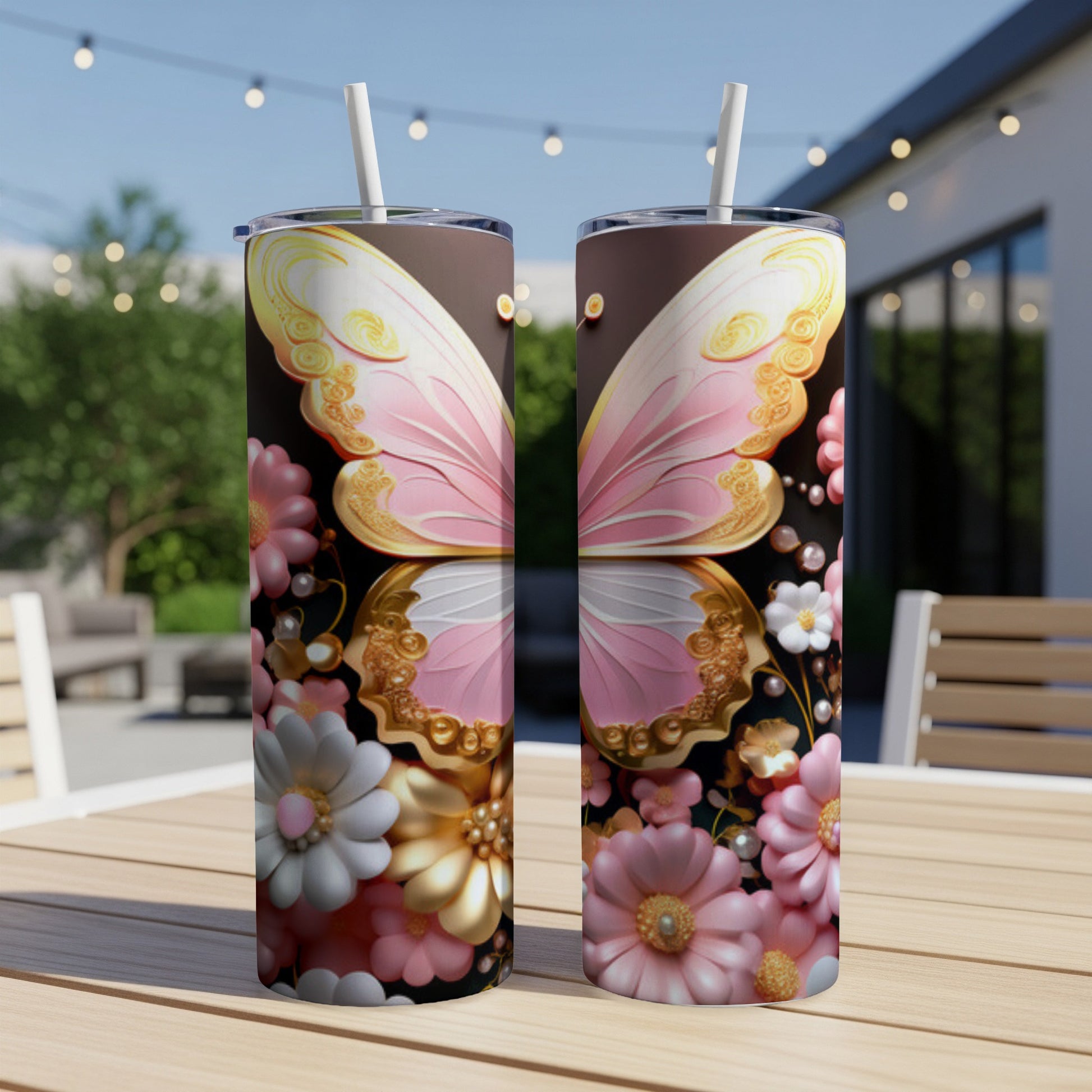Two tumblers with pink butterfly wings and floral designs on a wooden table.