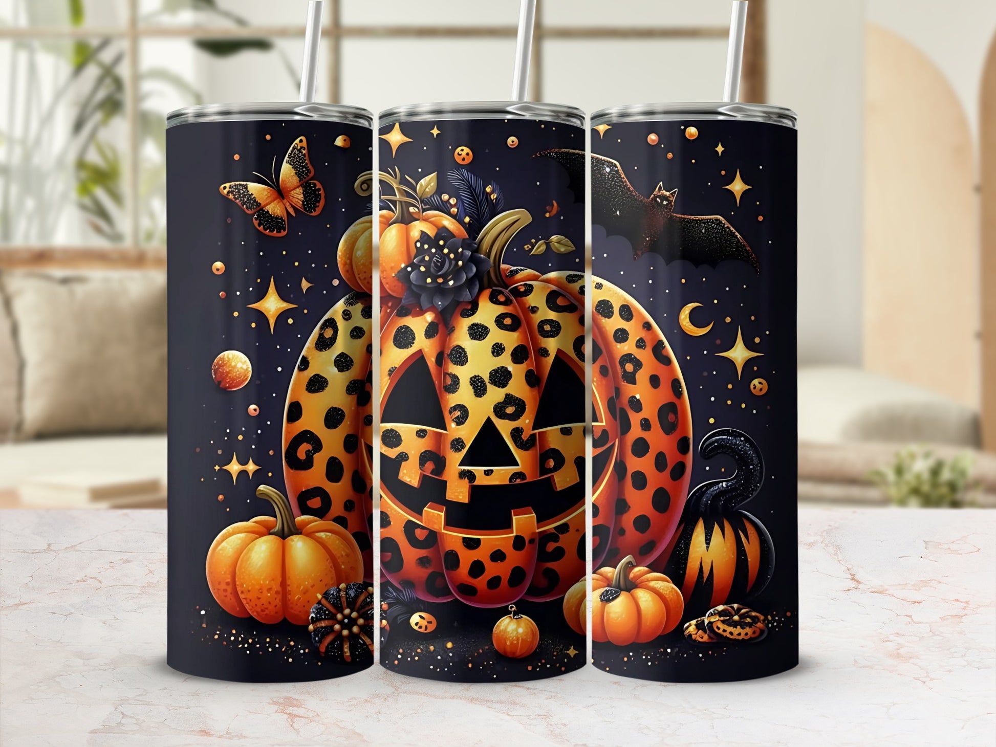 Halloween tumblers featuring pumpkins, bats, butterflies, and stars on a dark background.