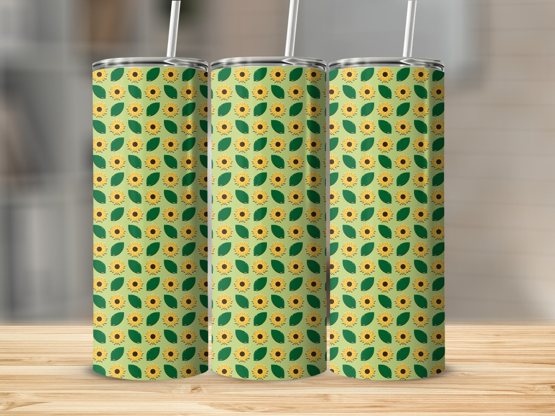 Three tumblers with a repeating sunflower and leaf pattern.