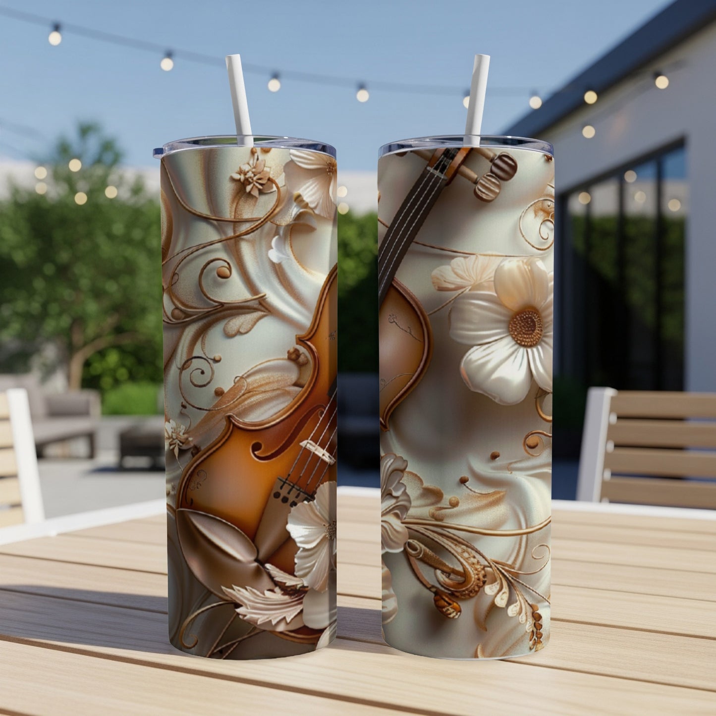 Two tumblers with ornate floral and violin designs sit on a table.